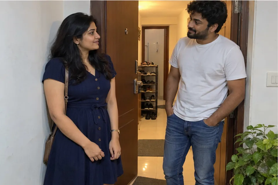 A woman in a navy dress at the open door of an ordinary flat, a man in a white T-shirt inside the doorway